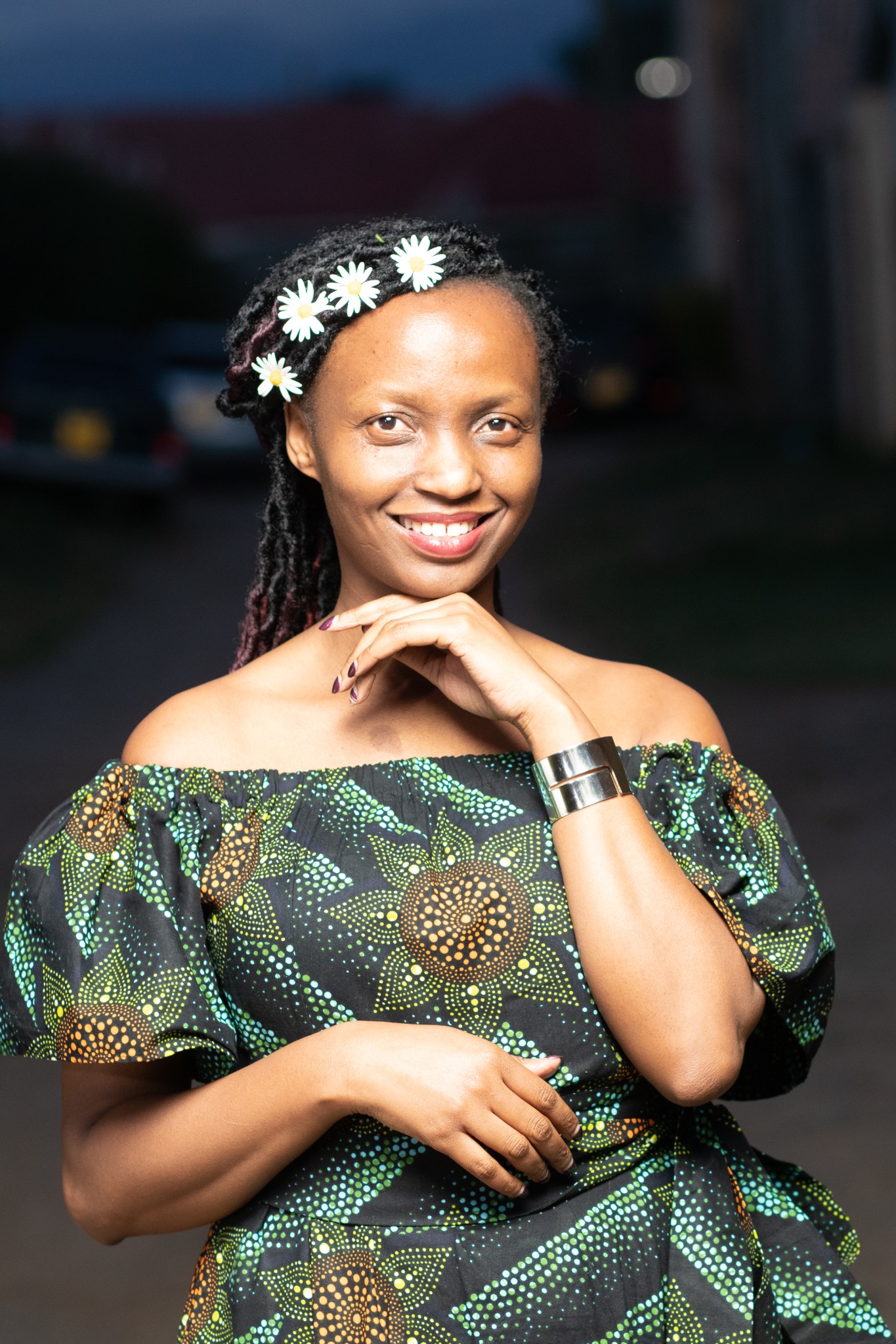 Bilha smiling in a patterned dress