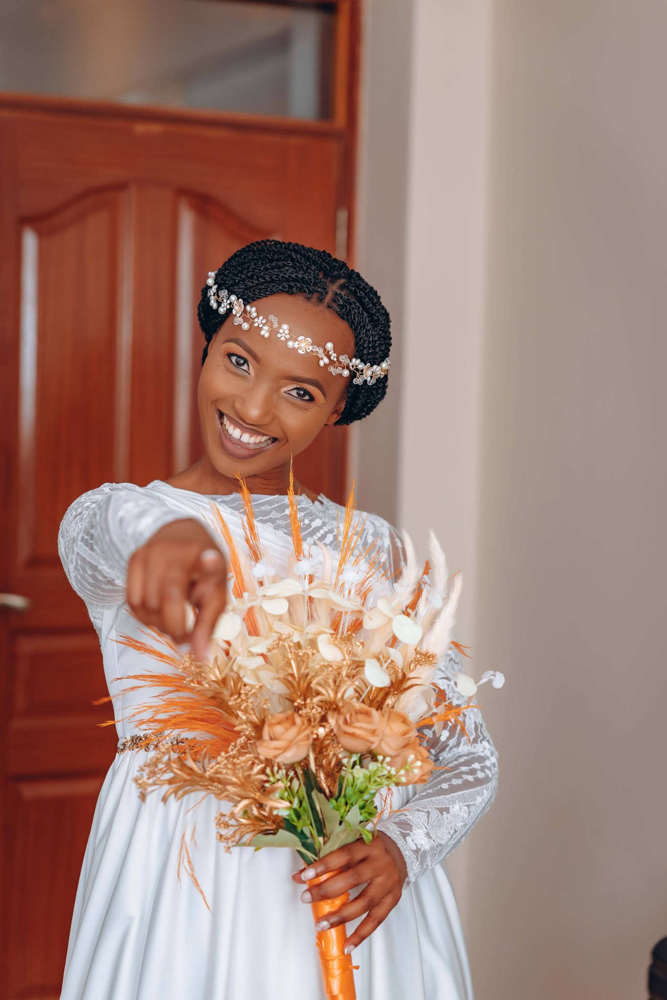 Bilha smiling in a white dress